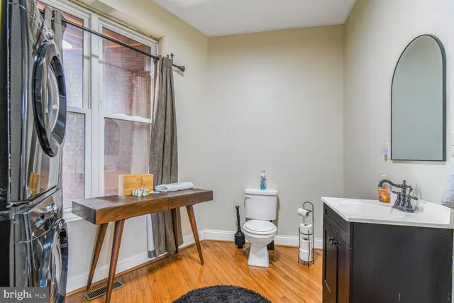 a bathroom with a sink a toilet and a mirror
