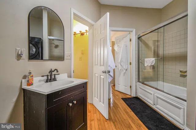 a bathroom with a sink a mirror and a shower