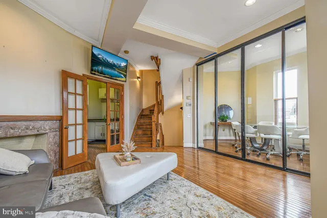 a living room with furniture and a floor to ceiling window