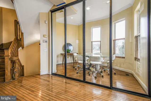 a view of an entryway with wooden floor and door