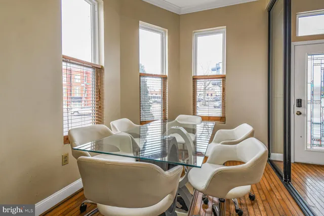 a dining room with furniture and wooden floor