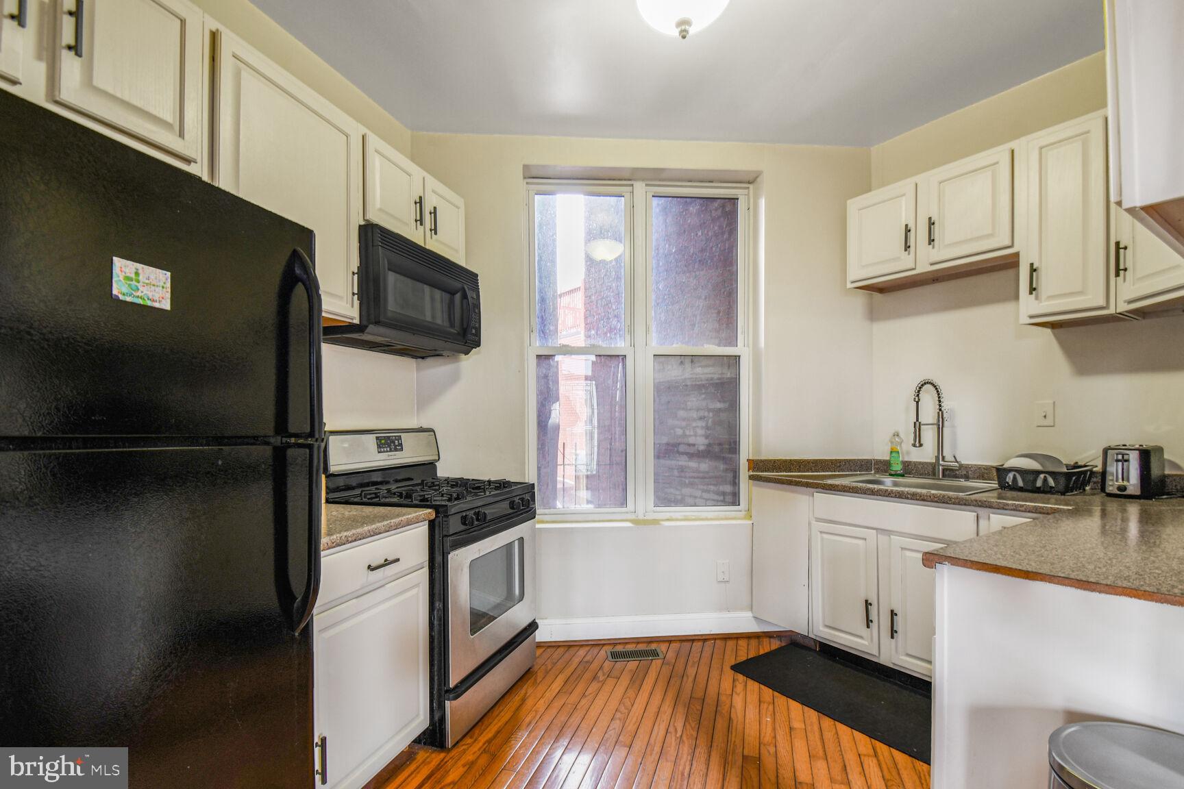 414 Florida Avenue Northwest Washington, DC 20001 - Photo 6 of 24 a kitchen with stainless steel appliances a sink a stove a microwave and refrigerator