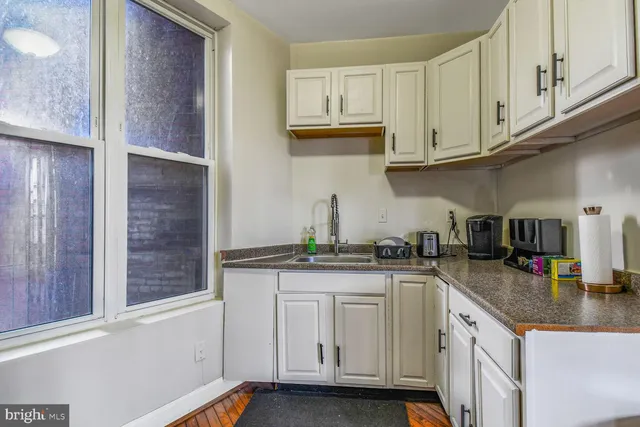 a kitchen with stainless steel appliances granite countertop a sink and cabinets