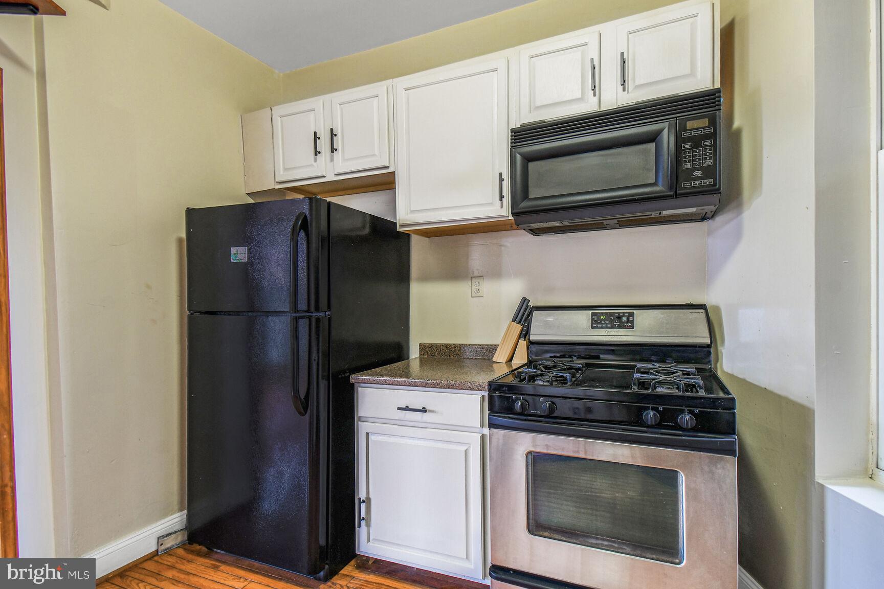 414 Florida Avenue Northwest Washington, DC 20001 - Photo 8 of 24 a kitchen with stainless steel appliances granite countertop white cabinets a refrigerator and a stove top oven
