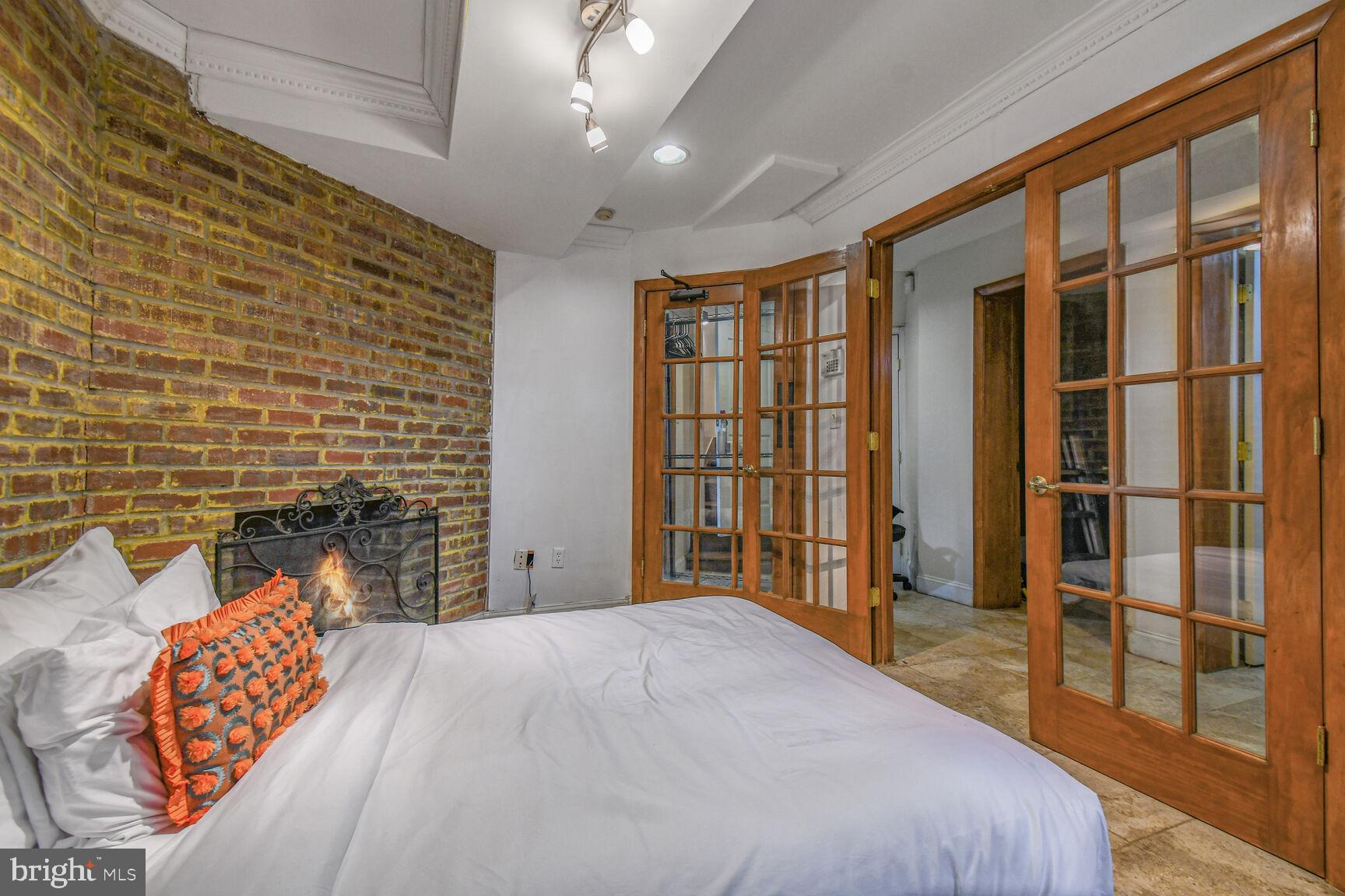 414 Florida Avenue Northwest Washington, DC 20001 - Photo 10 of 24 a bedroom with a bed and wooden floor