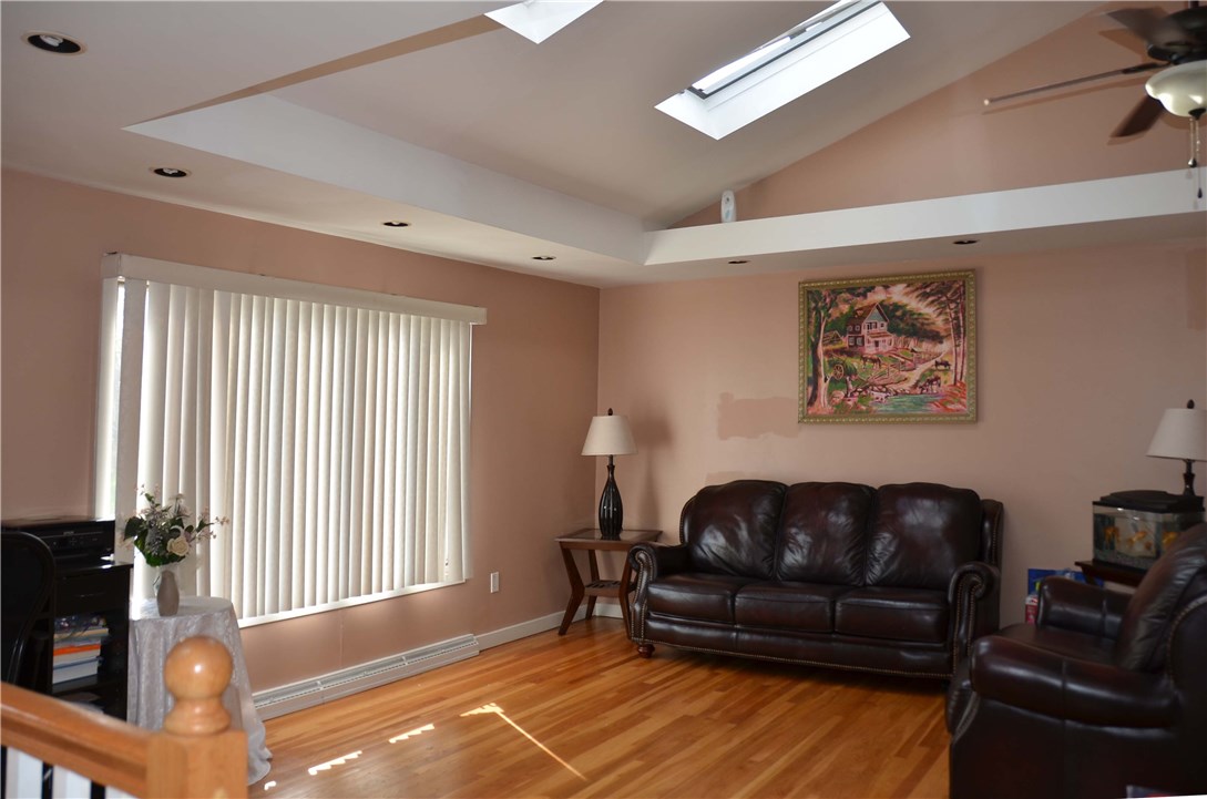 239 Sandy Lane Warwick, RI 02889 - Photo 11 of 22 Hardwoods in living room, bright sunny windows, sky lights, very unique vaulted ceilings through living room, dining and kitchen!