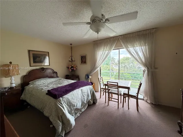 a bedroom with a bed and a balcony