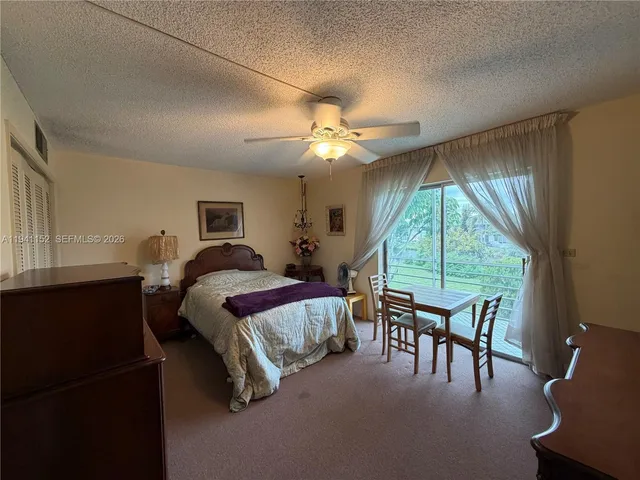 a bed room with a bed and a large window