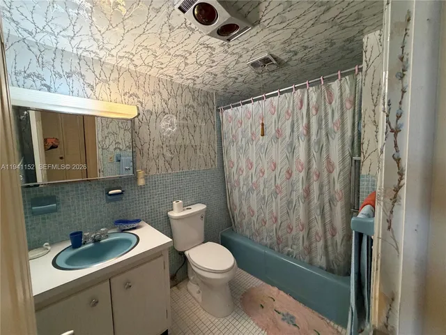 a bathroom with a toilet sink and shower