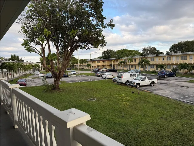 a car parked in front of a house with a big yard