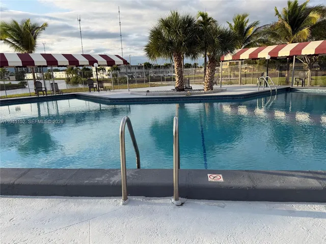 a view of swimming pool with outdoor seating