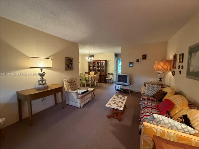 a living room with furniture and a lamp