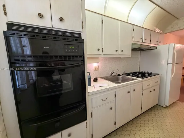 a kitchen with stainless steel appliances a stove microwave and cabinets