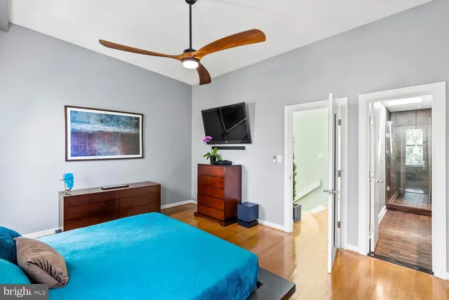 a bedroom with a bed and a flat screen tv