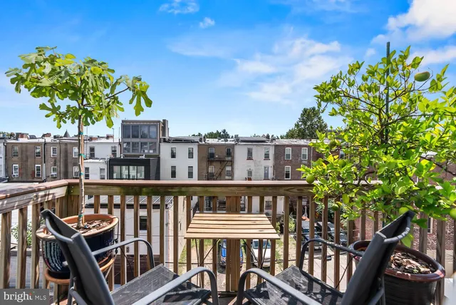 a balcony with table and chairs