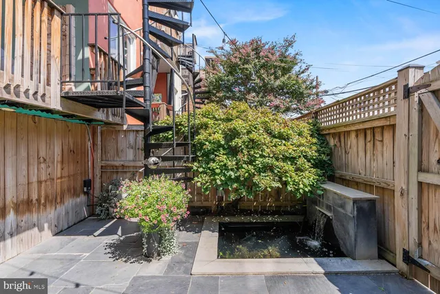 a view of a pathway along with potted plants