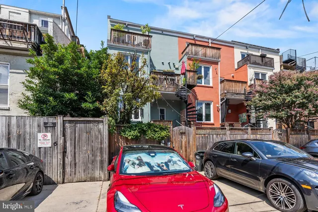 a couple of cars parked in front of a house