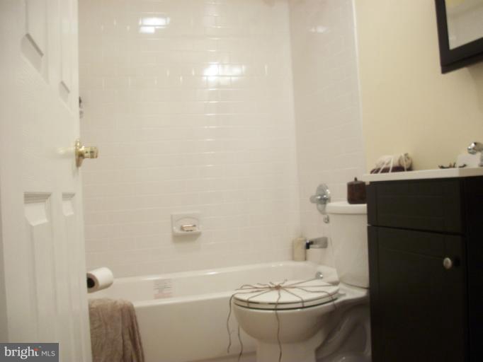 2733 Yarnall Road Halethorpe, MD 21227 - Photo 29 of 30 a bathroom with a granite countertop sink toilet and shower