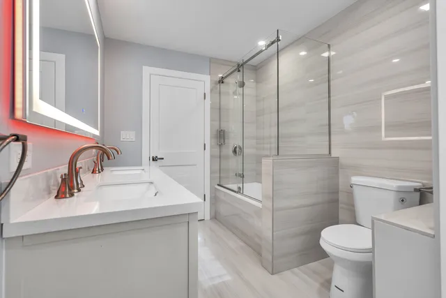 a bathroom with a sink toilet and shower