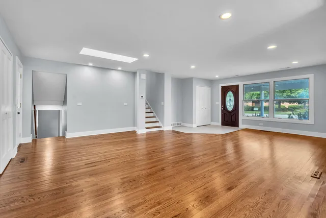 a view of a livingroom with wooden floor and window