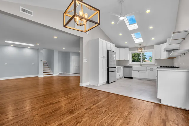 a view of a kitchen with stainless steel appliances refrigerator and microwave