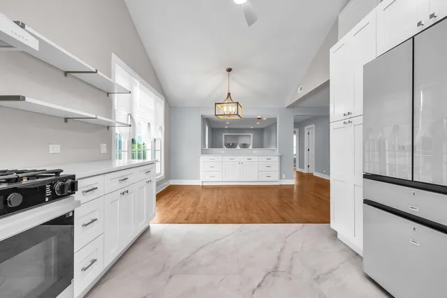 a large kitchen with a stove and a refrigerator