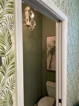 a bathroom with a toilet and a shower curtain