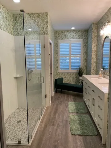 a bathroom with a tub shower and sink