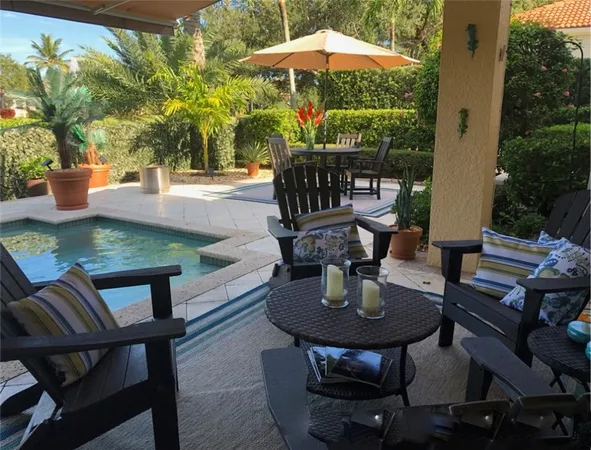a view of a patio with table and chairs potted plants with wooden floor
