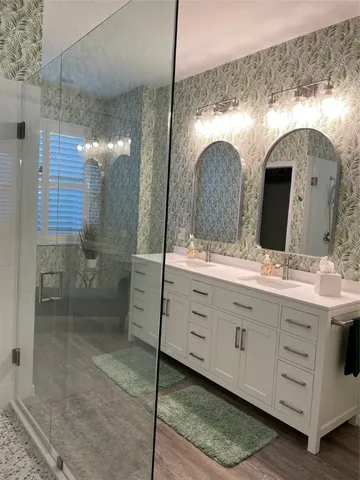 a bathroom with a double vanity sink and a mirror