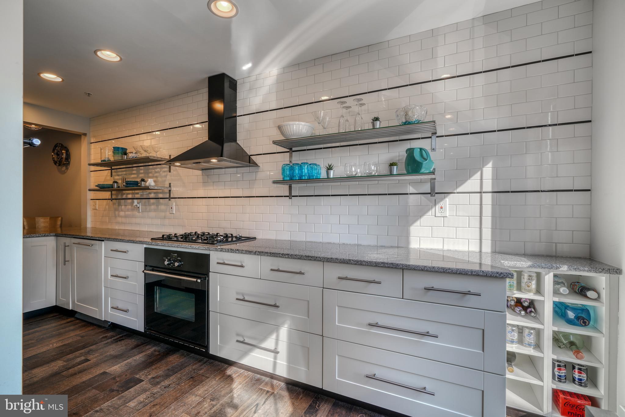 a kitchen with stainless steel appliances granite countertop a stove and a refrigerator