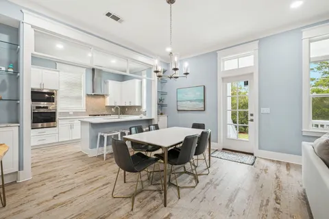 a bathroom with a granite countertop sink a large mirror and a bathtub
