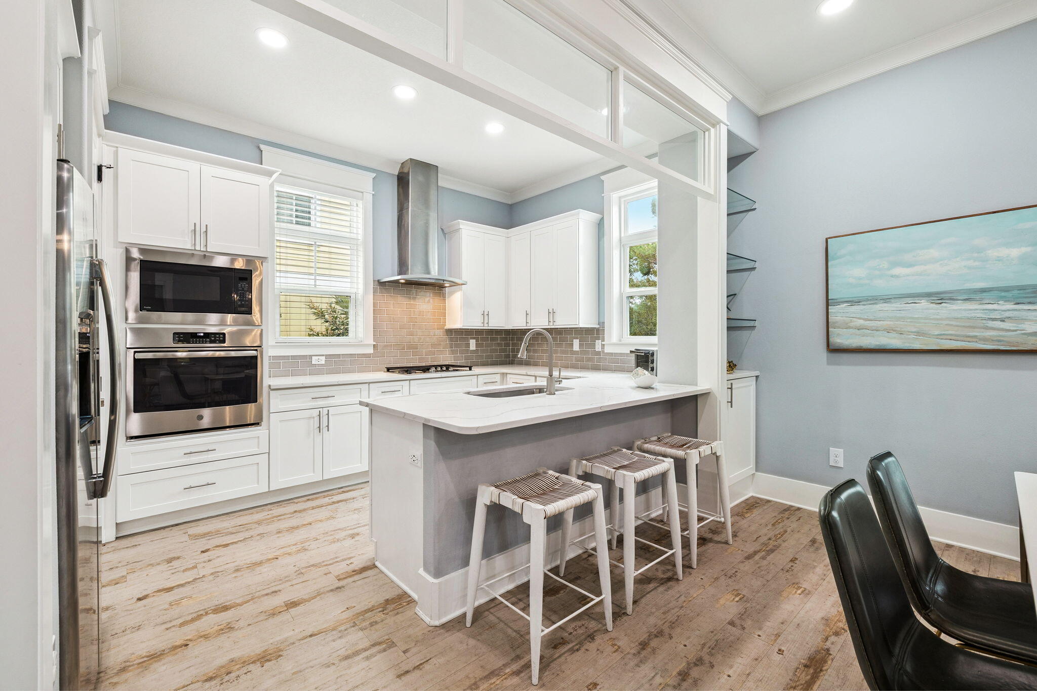 135 Gulfview Circle Santa Rosa Beach, FL 32459 - Photo 24 of 49 a kitchen with a table chairs microwave and cabinets