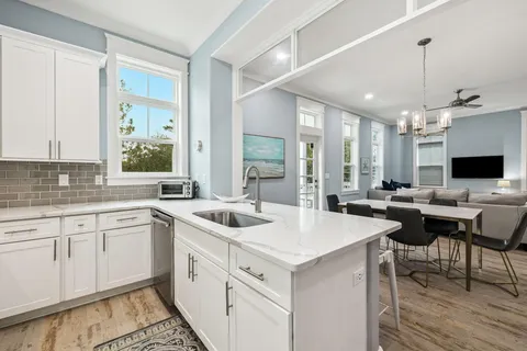 a view of a patio with a table and chairs under an umbrella