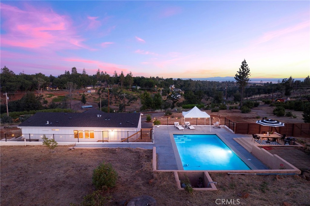 343 Roe Road Paradise, CA 95969 - Photo 1 of 1 a view of a swimming pool with a table and chairs
