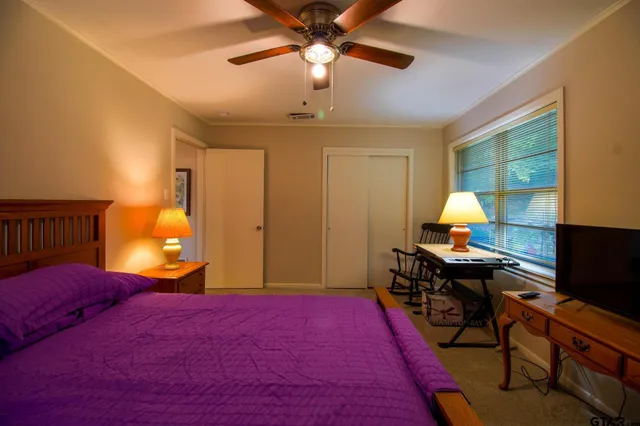 a view of a chair and table in backyard of the house