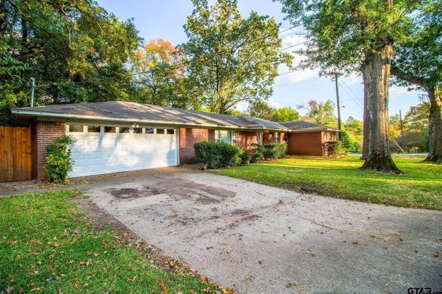 a view of house with outdoor space and garden