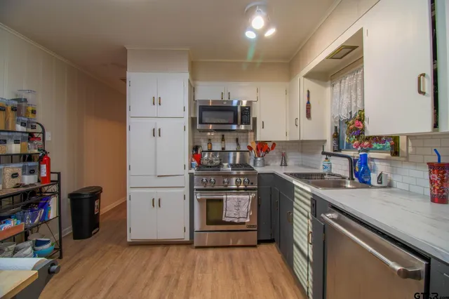 a view of a workspace with furniture window and wooden floor