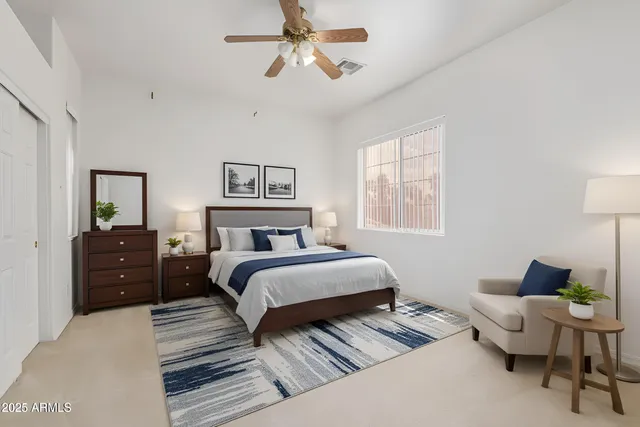 an empty room with windows and fan