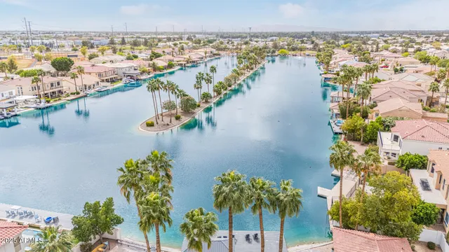a view of a house with a yard and lake view