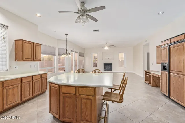 a large white kitchen with a sink and a refrigerator