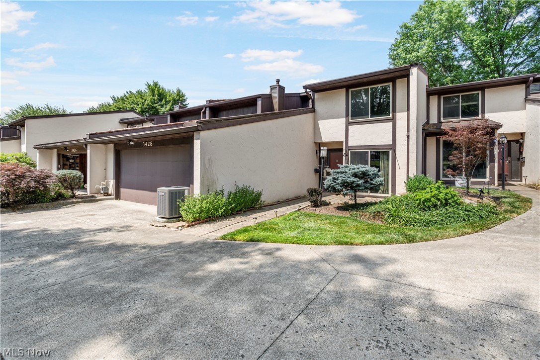 3428 South Smith Road Fairlawn, OH 44333 - Photo 1 of 30 View of front facade featuring a garage and central air condition unit