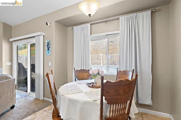 a dining room with furniture and window