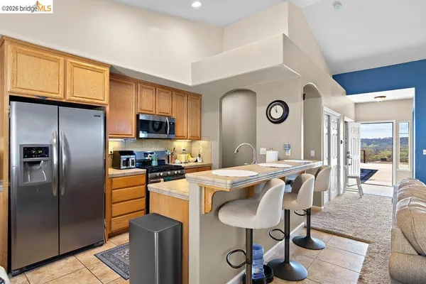 a kitchen that has a lot of cabinets a sink and a stove in it