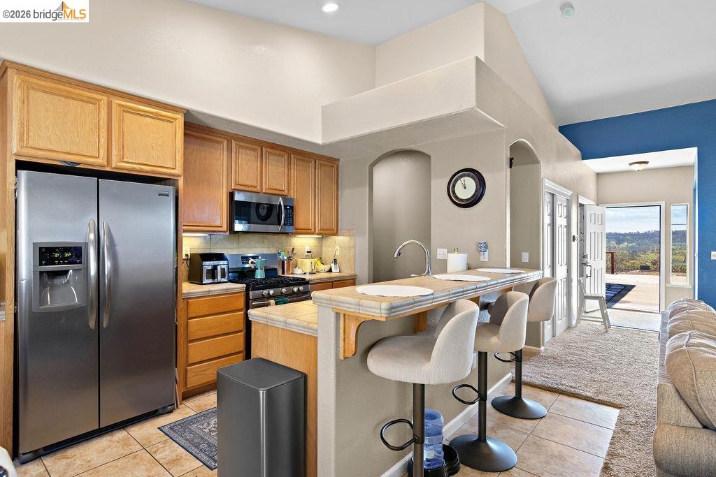 4955 Little John Road Copperopolis, CA 95228 - Photo 11 of 60 a kitchen with stainless steel appliances granite countertop a stove a sink a refrigerator and chairs