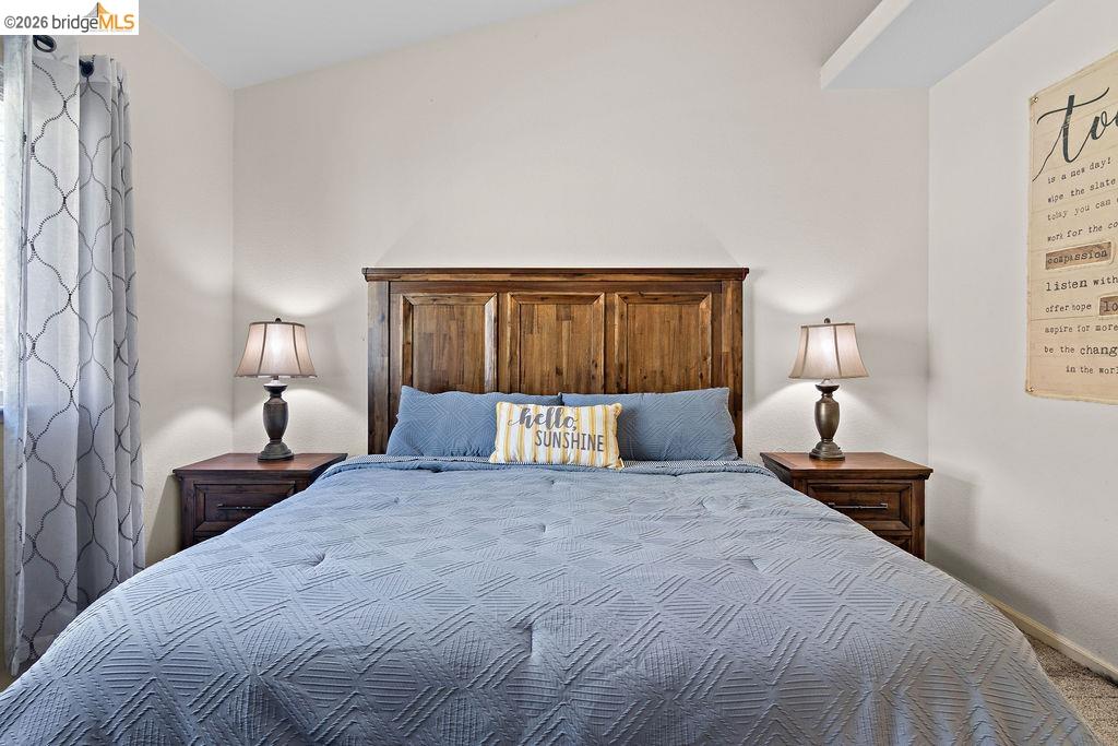 4955 Little John Road Copperopolis, CA 95228 - Photo 14 of 60 a bedroom with a large bed and a lamp