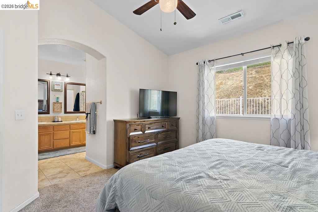 4955 Little John Road Copperopolis, CA 95228 - Photo 15 of 60 a bedroom with a large bed and a flat screen tv