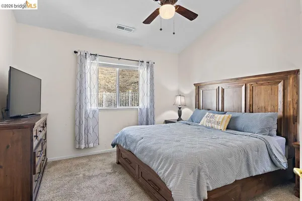 a bedroom with a large bed and a flat screen tv