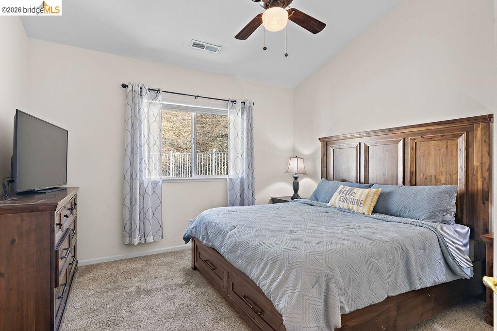 4955 Little John Road Copperopolis, CA 95228 - Photo 16 of 60 a bedroom with a large bed and a flat tv screen on dresser