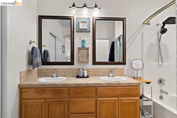 a bedroom with a large bed and a flat tv screen on dresser